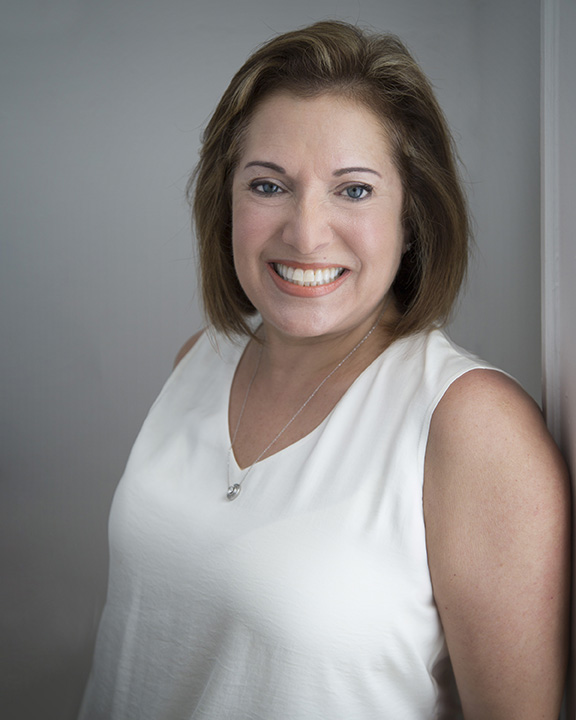 Professional headshot of a woman with confident expression, Janet Joyner Photography